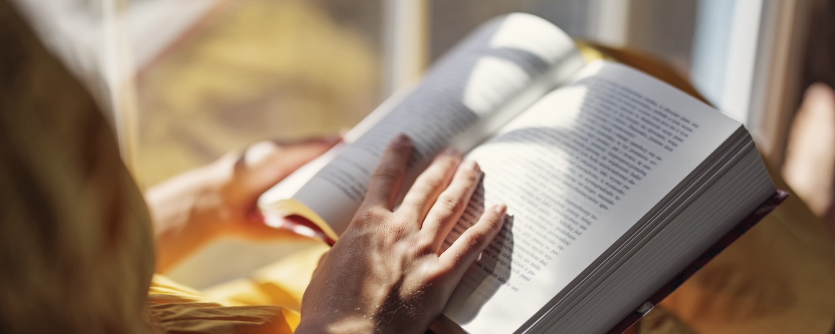 Person holding an open book