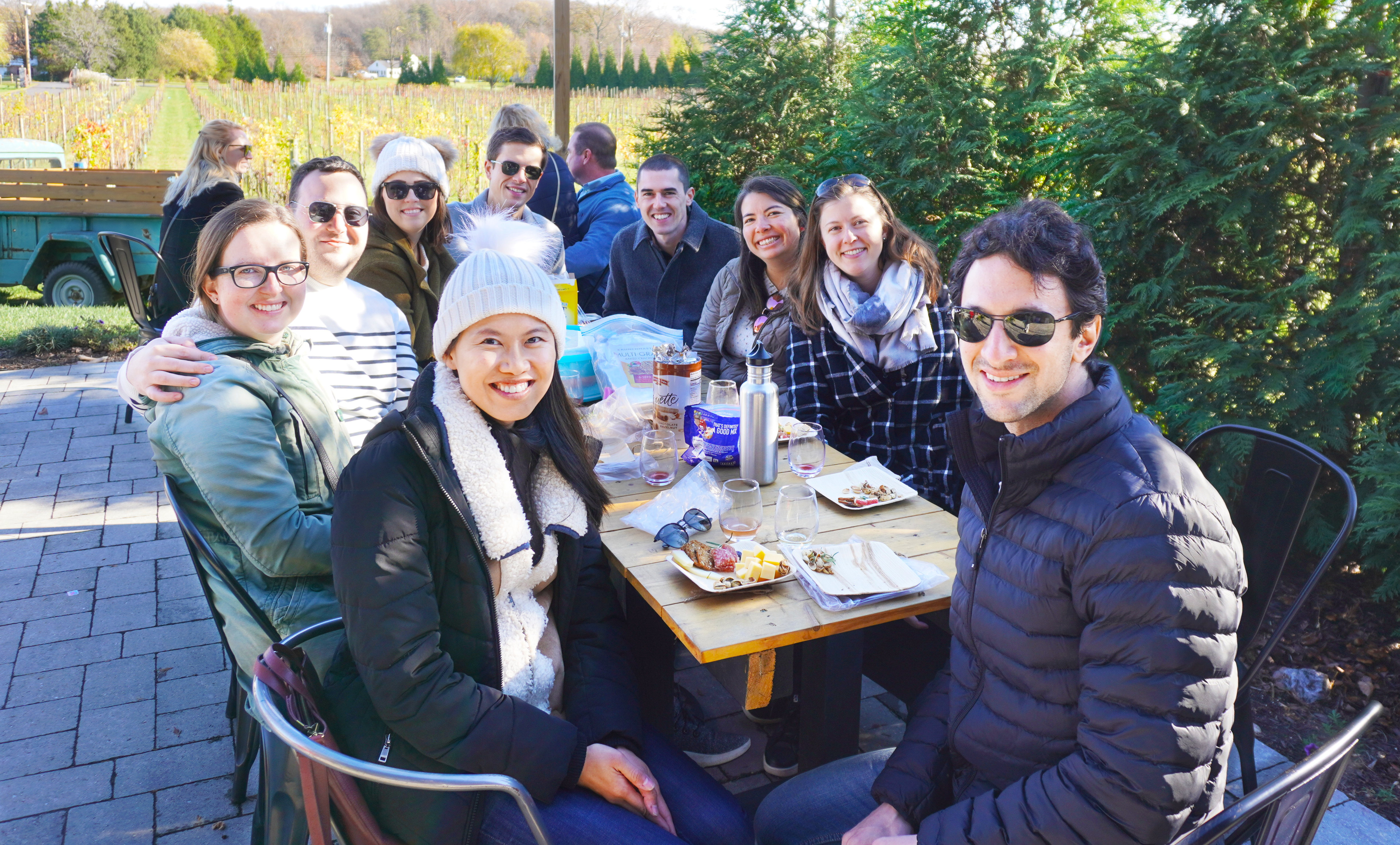 A group of people sitting at a table outdoors.