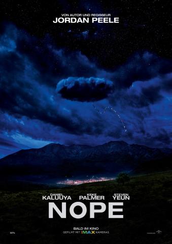 Poster for the film Nope. In a dark stormy and cloudy sky there is a suspicious cloud with a flagged streamer hanging down from it. The rest of the image is of a lonely gulch with a lit up western theme park in the distance.