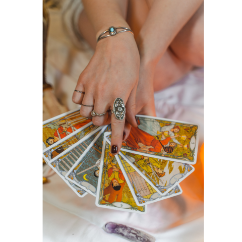 Hands holding Tarot cards