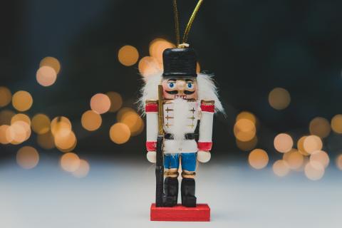 nutcracker doll in front of sparkly lights