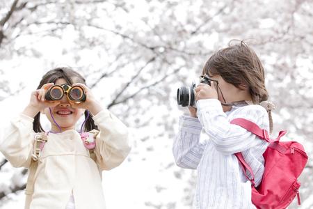 kids looking through binoculars in the winter