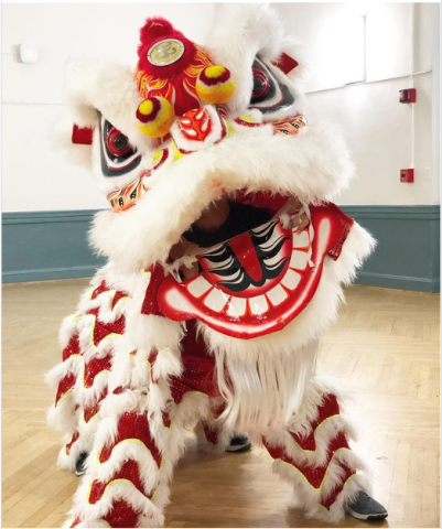 Photo from JHU Yong Han Lion Dance Troupe, pictured a white Chinese Lion named Sir Acha