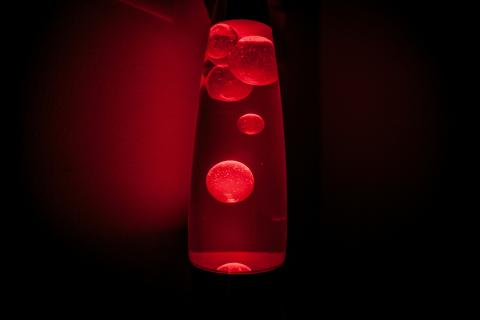 Red lava lamp on dark background