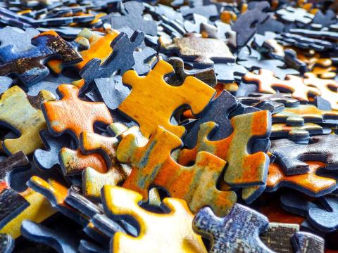 An image of dozens of colorful puzzle pieces.