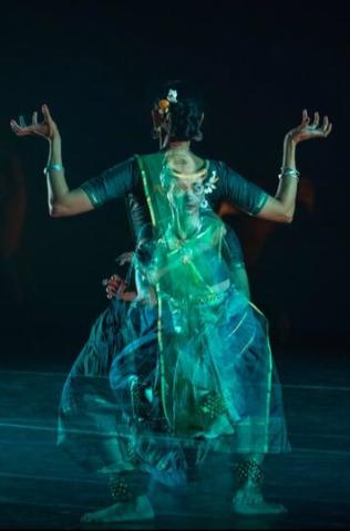 A dancer wearing ocean greens and blues poses and is visible from many angles.