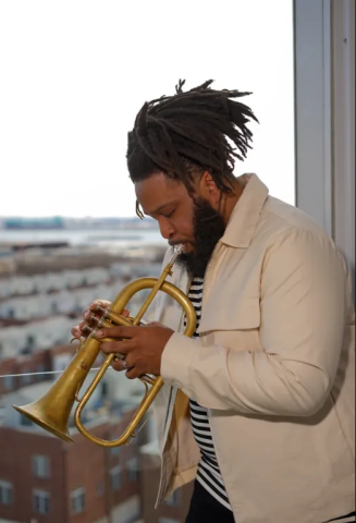 Clarence Ward III playing the flugelhorn in front of a city skyline