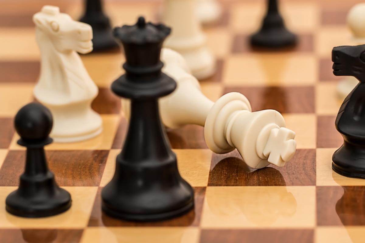 Black and white chess pieces displayed on a chess board