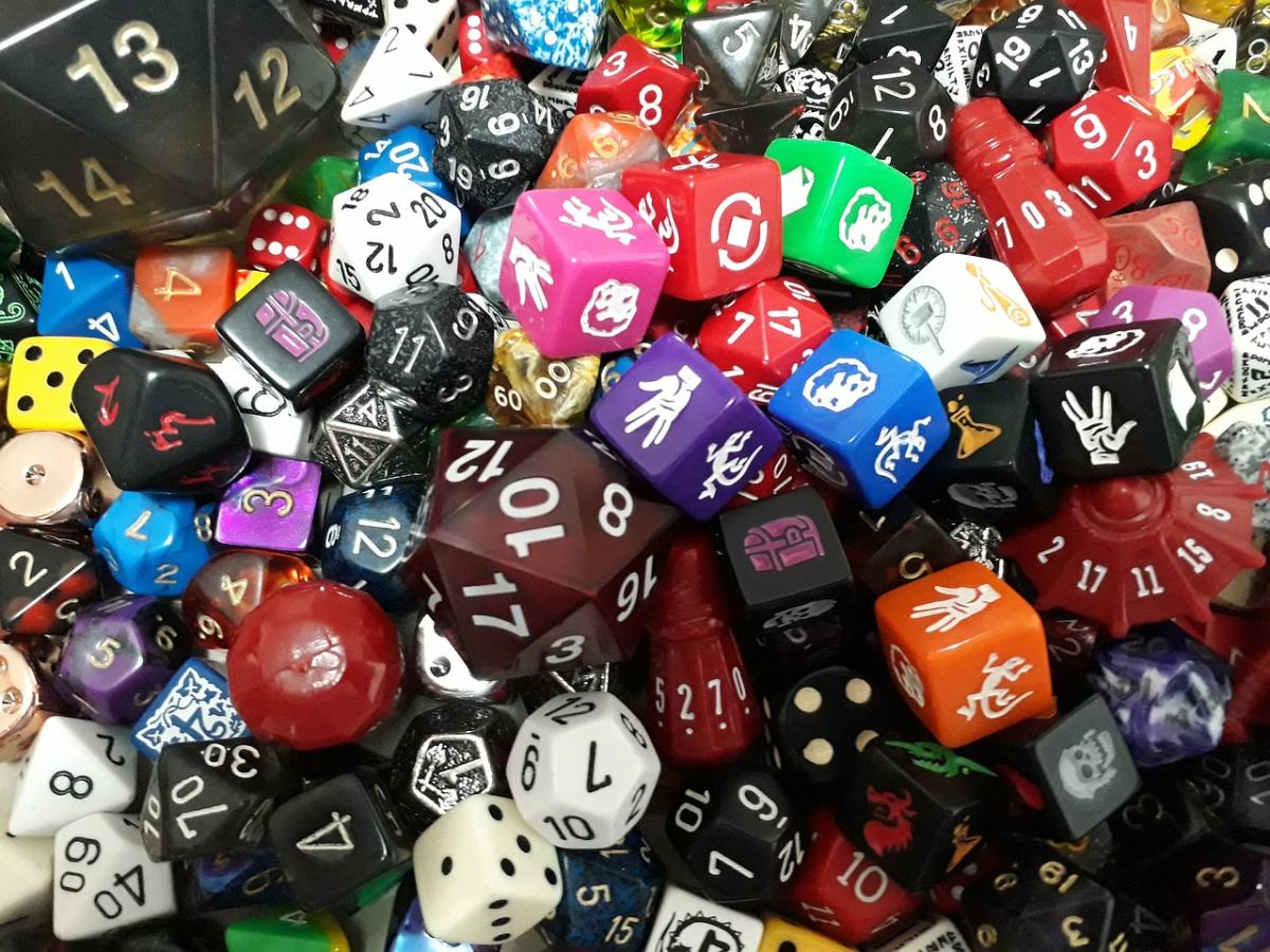 An image of dozens of colorful dice of various sizes.