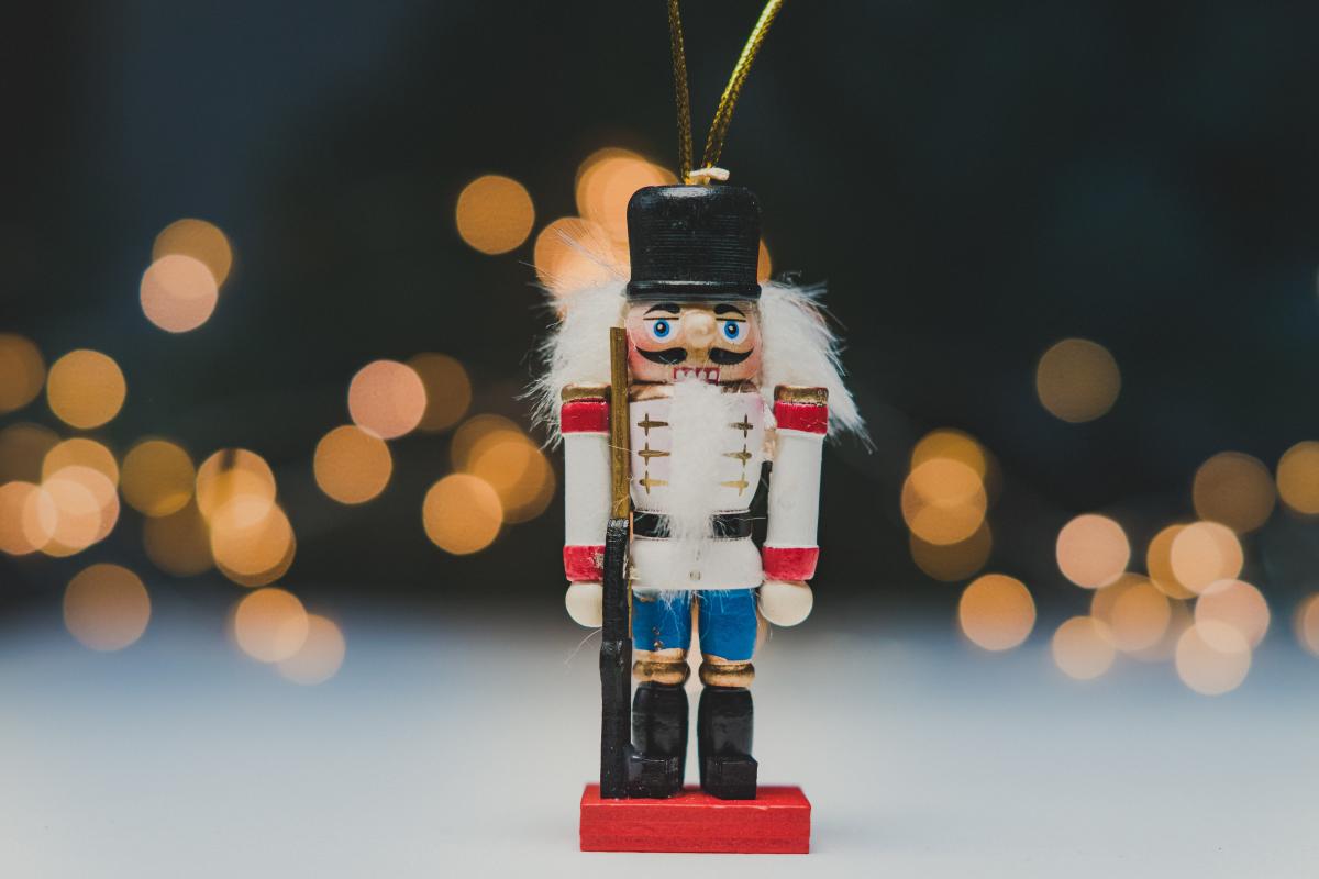 nutcracker in front of sparkling lights 