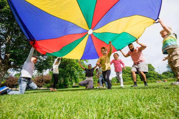 Kids playing with a parachute outside